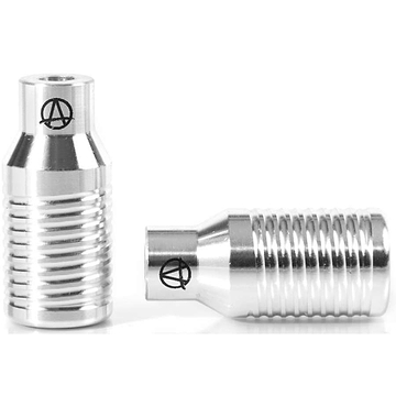 Two raw silver objects crafted from aluminium with ridged surfaces and an engraved "A" inside a circle. They are lightweight yet durable, with one positioned upright and the other horizontally. They feature a shiny, polished finish reminiscent of Apex Bowie Aluminium Stunt Scooter Pegs by Apex.