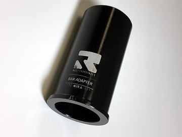 A black cylindrical object labeled "Root Industries HIC Stunt Scooter Bar Adapter - Oversized" sits on a white background, designed for seamless integration with any SCS Stunt Scooter. The metallic adapter boasts a smooth, gleaming finish, ideal for riders seeking top-notch performance and style.