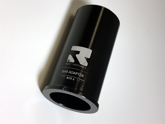 A black cylindrical object labeled "Root Industries HIC Stunt Scooter Bar Adapter - Oversized" sits on a white background, designed for seamless integration with any SCS Stunt Scooter. The metallic adapter boasts a smooth, gleaming finish, ideal for riders seeking top-notch performance and style.