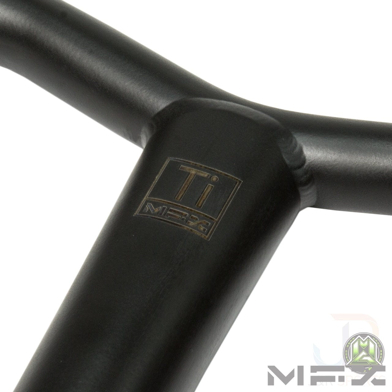 Close-up of a black metal handlebar from the Madd Gear MGP MFX BAMF Titanium Oversized SCS Stunt Scooter Bar, featuring the "MGP" logo on the stem. The bar is crafted from Grade 9 Titanium and the image is set against a white background with an additional logo in the bottom right corner.