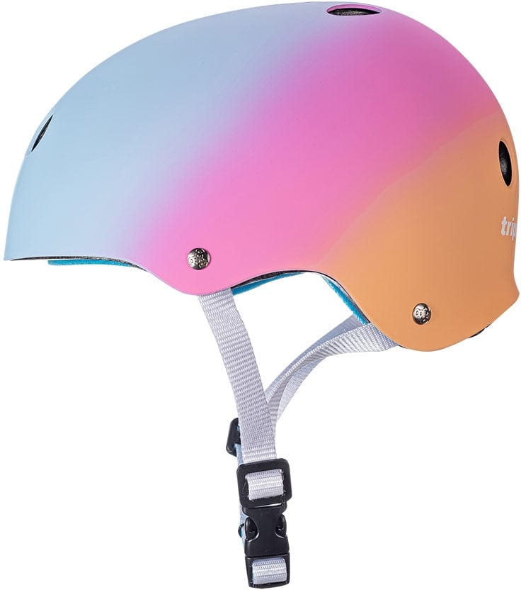 The Triple 8 Certified Sweatsaver Skate Helmet - Sunset boasts a chic blue to pink to orange gradient design with ventilation holes. It provides dual-certified protection featuring high-impact absorbing EPS foam and includes a white adjustable strap with a black buckle for a secure fit.