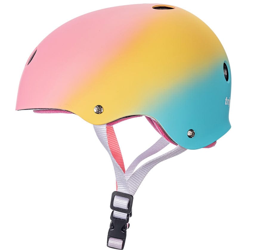 The Triple 8 Certified Sweatsaver Skate Helmet - Shaved Ice presents a stunning gradient design in pink, yellow, and blue. It includes ventilation holes and a white adjustable strap with a black clasp for comfort. The helmet boasts high-impact absorbing EPS foam and dual-certified protection for enhanced safety.