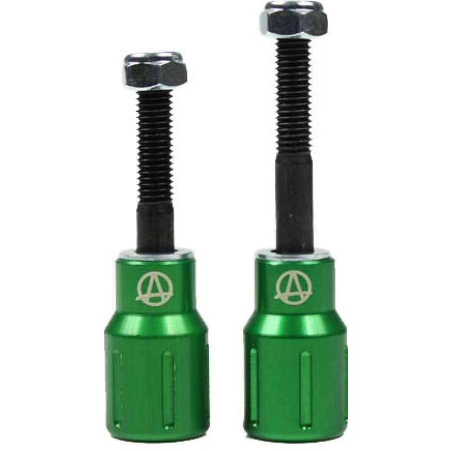 The Apex Barnaynay Aluminium Stunt Scooter Pegs in green are two sleek metal tools, each with a threaded black screw on top. One is taller than the other, both showcasing the Apex logo, which resembles a stylized "A," on their bodies. These robust pegs are ideal for enhancing your trick scooter's performance and style.