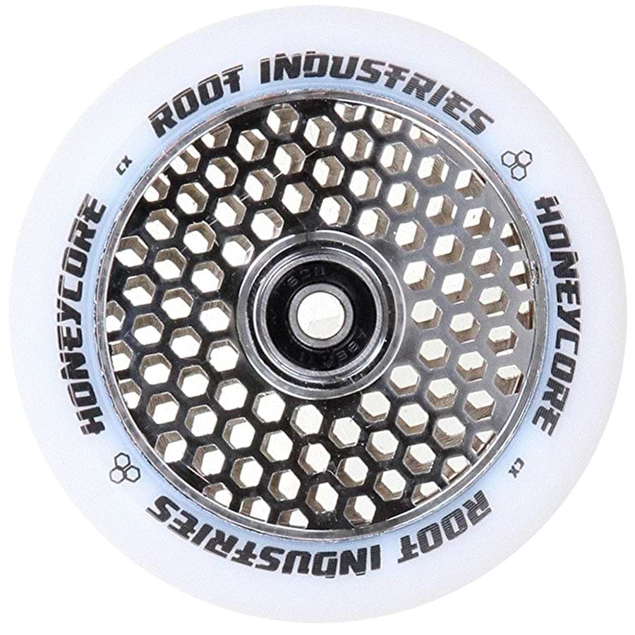 This close-up of the Root Industries Honeycore 110mm Stunt Scooter Wheel highlights its eye-catching honeycomb pattern within the mirror chrome metal core. The elegant white outer rim prominently features "Root Industries Honeycore" in bold black lettering, surrounding a precision central bearing.