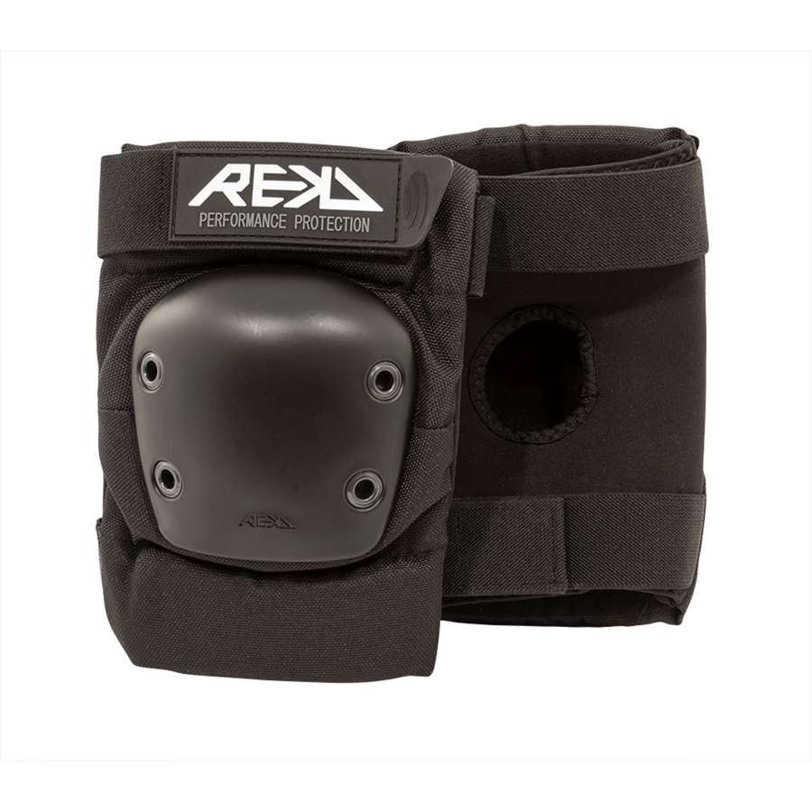 The REKD Ramp Elbow Skate Protection Pads in black, engineered with impact-resistant reinforced plastic caps and adjustable straps, are designed for action sports. The pads are displayed on a white background, one highlighting the front and the other featuring the back with a circular opening.