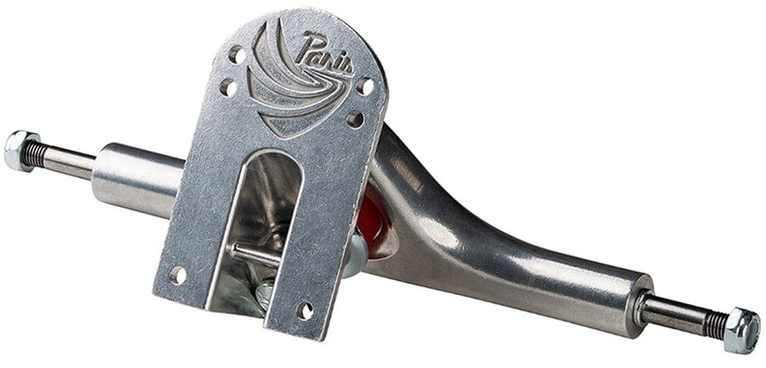 The close-up reveals a Paris V3 Polished Chrome Longboard Truck with the brand name prominently embossed on top. Its sleek design is crafted using a proprietary alloy forming process, featuring visible bolts and a distinctive red bushing in the center.