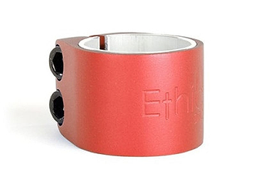 The Ethic DTC Basics 2 Bolt Oversized Stunt Scooter Clamp in red is a high-quality aluminum clamp with two black hex screws and etched text on its side, perfect for securing your stunt scooter's oversized handlebars.
