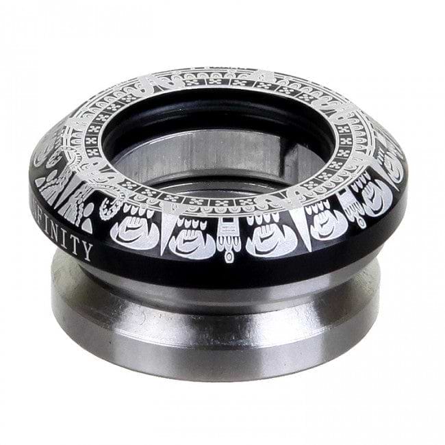 Close-up of a metal and black circular object with intricate white patterns around the top edge. The word "INFINITY" is engraved on the side, denoting its craftsmanship by Infinity. Made from CNC milled aluminum, it seems to be a component of the Infinity Mayan Integrated Stunt Scooter Headset in Black.
