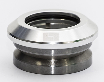 Close-up of the Logic Integrated Stunt Scooter Headset in silver, a metallic mechanical component with a smooth, shiny surface and a hollow center. This circular piece is set against a plain white background, highlighting its precision design.