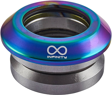 A Neochrome ring, crafted with a vibrant iridescent finish, sits atop a silver metallic base made from CNC milled aluminum. It features a white infinity symbol and the word "INFINITY," reflecting the precision found in Infinity's Integrated Stunt Scooter Headset.