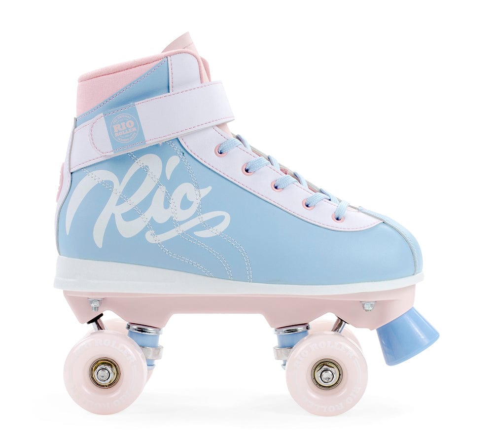 The Rio Roller Milkshake Quad Roller Skates - Cotton Candy, designed by Rio Roller, boast a charming pastel blue and pink color scheme with white laces and a Velcro strap. Adorned with "Rio" in large cursive letters, these skates blend the allure of pastel hues with the traditional figure skate style, featuring four wheels and a toe stop for leisurely enjoyment.
