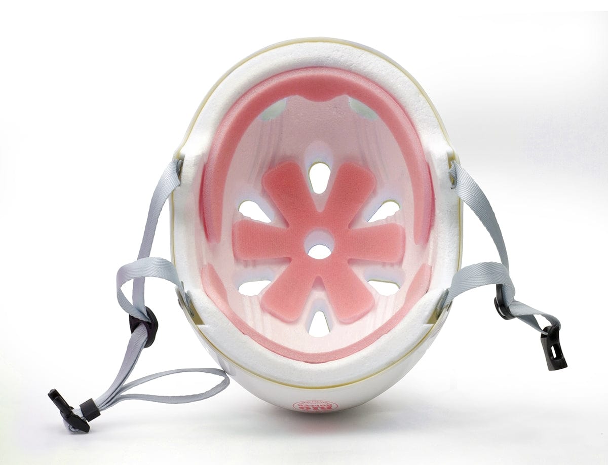 A look inside the Rio Roller Script Skate Helmet in white reveals its pink foam padding and ventilation openings, designed to provide superior impact resistance. The gray adjustable straps can be seen on both sides.