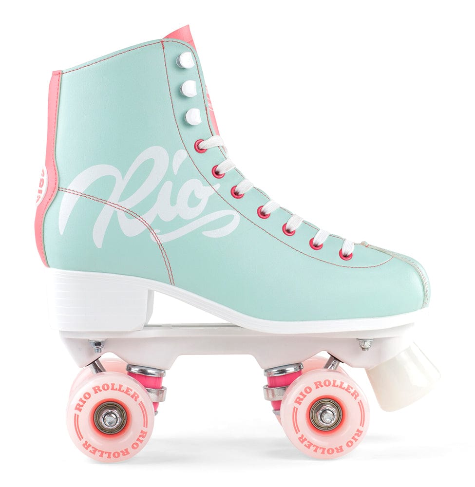 The Rio Roller Script Quad Roller Skates in Teal and Coral feature a stylish mint green and pink design with white laces and wheels. The skates proudly display "Rio" in large script across the side. They are crafted from PVC leather, complemented by a white sole and a pink heel tab, blending retro style with contemporary colors for the ideal quad roller skates.