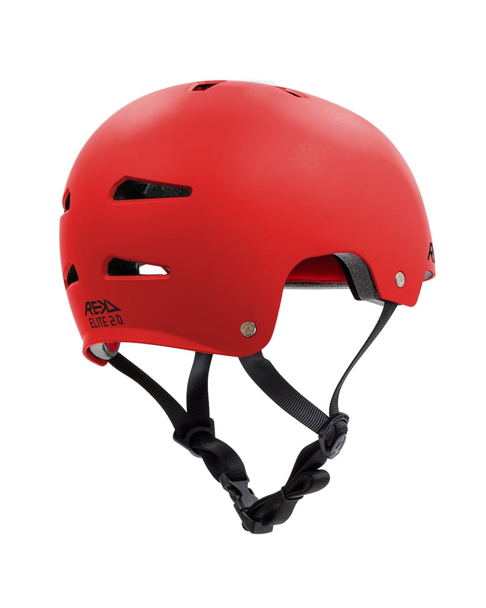 The REKD Elite 2.0 Skate / Scooter Helmet in red features a stylish design with a smooth surface and an adjustable black chin strap. It is designed for comfort during action sports, offering multiple ventilation slots. The helmet's side proudly displays "Apex Elite 2.0," emphasizing its exceptional protection under REKD Protection standards.