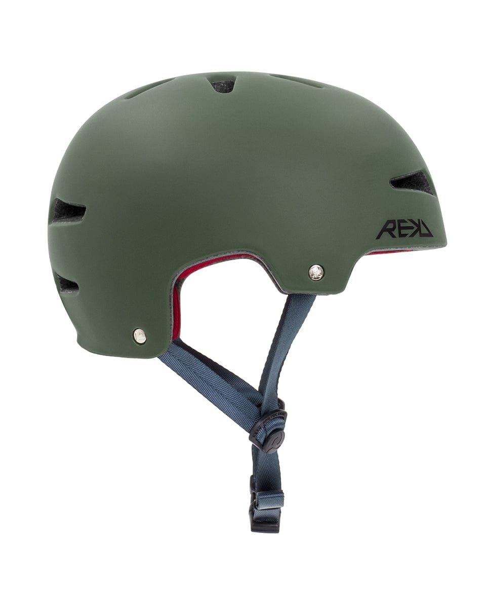 The REKD Ultralite In-Mold Skate / Scooter Helmet in green is a lightweight option designed for action sports. It includes a red interior lining, a black adjustable chin strap, small vents on top, and displays the sleek REKD logo on the side.