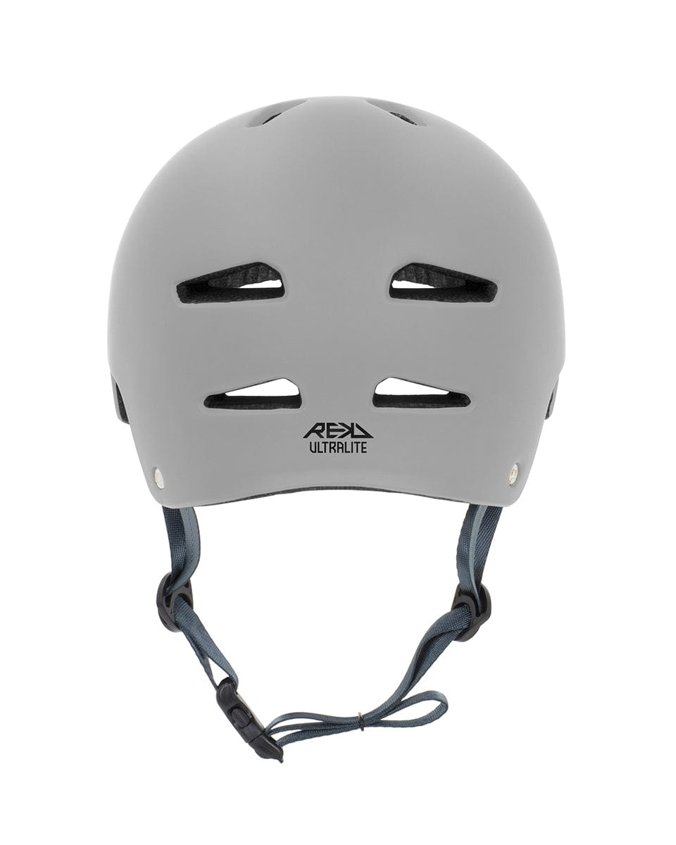 Front view of a gray REKD Ultralite In-Mold Skate / Scooter Helmet featuring ventilation slots and a chin strap, with the "REKD ULTRALITE" logo prominently displayed. Engineered for safety in action sports, it utilizes In-Mold technology to provide enhanced protection for cycling or similar activities.