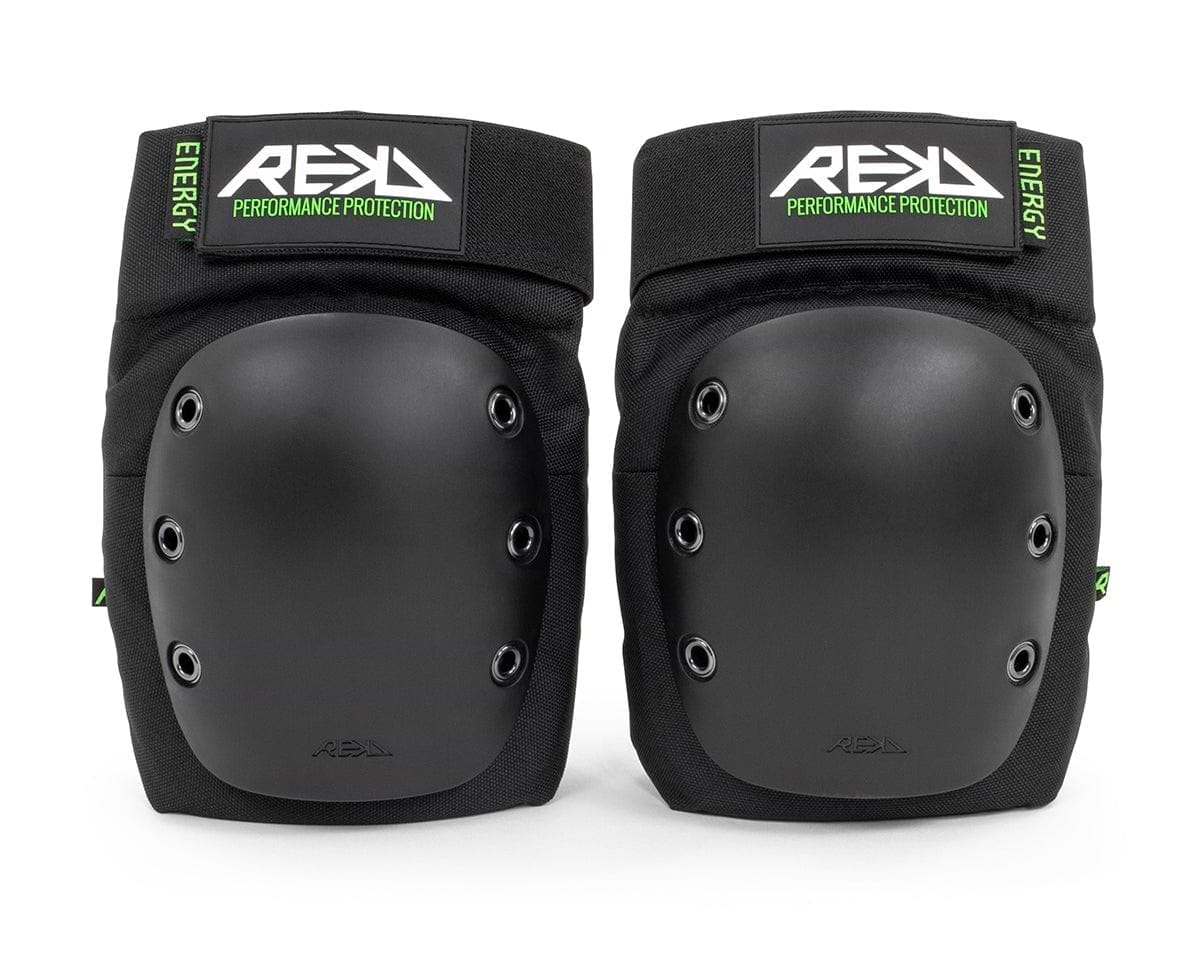 Introducing the REKD Energy Ramp Skate Protection Knee Pads - Black, designed with hard protective shells and impact foam for ultimate protection. These black knee pads offer adjustable straps for a snug fit and proudly feature "REKD" alongside "Performance Protection" on the bold green and black label.