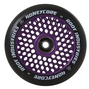 The Root Industries Honeycore 120mm Stunt Scooter Wheel in black and purple is displayed, showcasing an eye-catching honeycomb design. The inner core highlights the distinctive pattern, with "Honeycore Wheels" and "Root Industries" tastefully printed in white around the outer edge.