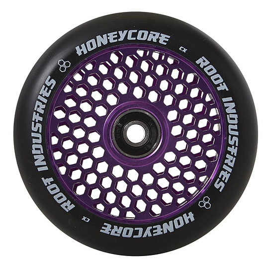 The Root Industries Honeycore 120mm Stunt Scooter Wheel in black and purple is displayed, showcasing an eye-catching honeycomb design. The inner core highlights the distinctive pattern, with "Honeycore Wheels" and "Root Industries" tastefully printed in white around the outer edge.