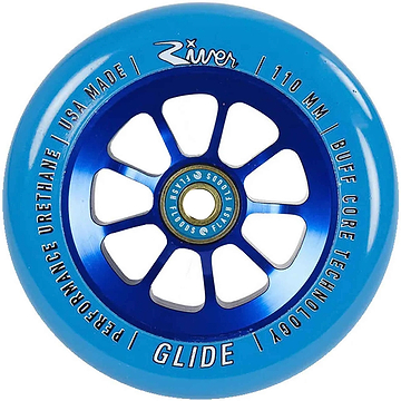 The River Glide 110mm Stunt Scooter Wheel in Sapphire Blue showcases white text around the edge with phrases like "River Glide Scooter Wheels," "Performance Urethane," and "Buff Core Technology." Its core is crafted from anodized 6061-T6 aluminum in metallic blue, featuring eight spokes. The wheel includes River Flash Flood bearings, is made in the USA, and measures 110 mm.