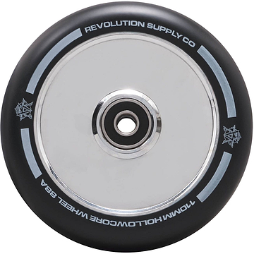 A close-up of a Revolution Hollowcore 110mm Stunt Scooter Wheel - Chrome showcases its black appearance with a metallic center bearing, displaying the words "Revolution Supply Co" and "110MM Hollowcore Wheel 88A" on the rim. This design by Revolution features a subtle star pattern along the edge.
