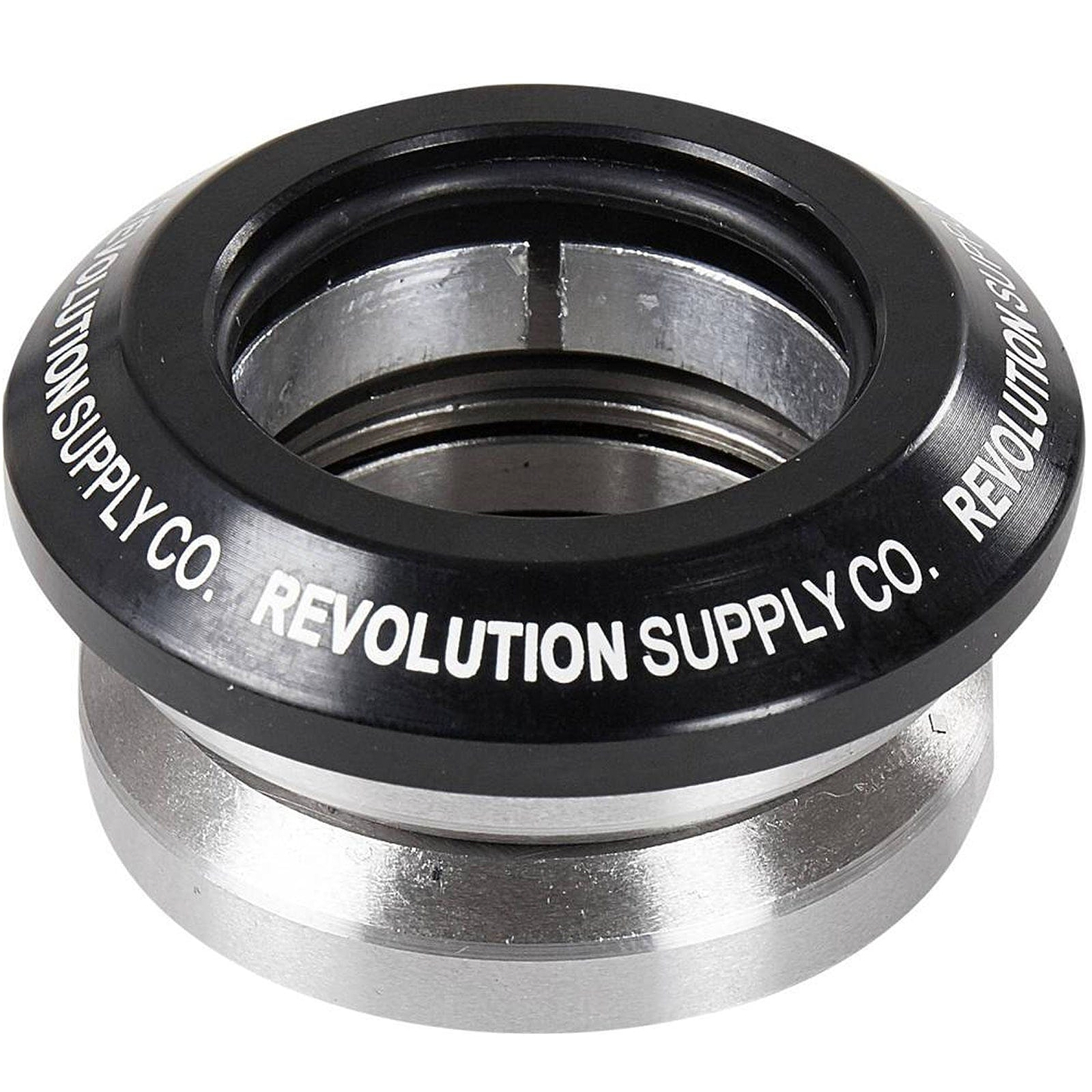 The Revolution Flow Integrated Stunt Scooter Headset in black, designed by Revolution, boasts a sleek black and silver component made from CNC milled aluminum. It elegantly displays the text "REVOLUTION SUPPLY CO." around the top edge. Equipped with sealed bearings, this headset ensures smooth rides.