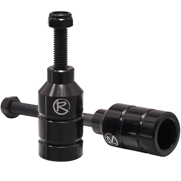 Two black Revolution Aluminium Stunt Scooter Pegs, designed from CNC milled aluminum, feature a cylindrical shape with a bolt on top for easy installation and the "R" logo on the side. Built to enhance your scooter's performance and durability, they offer precision engineering for stunts.