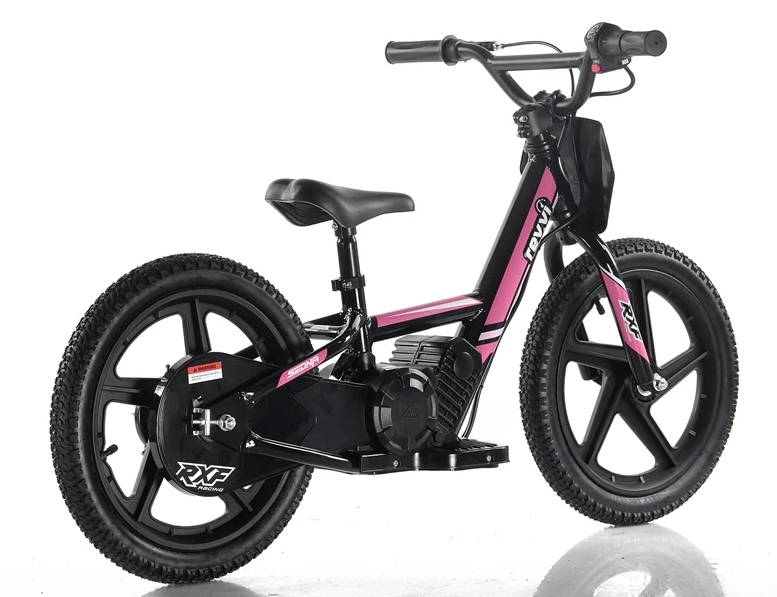 The Revvi 16" Kids Electric Balance Bike in pink boasts thick tires and a sturdy frame, complemented by a comfortable seat and handlebar grips. Ideal for young riders, this stylish bike is showcased on a reflective white surface.