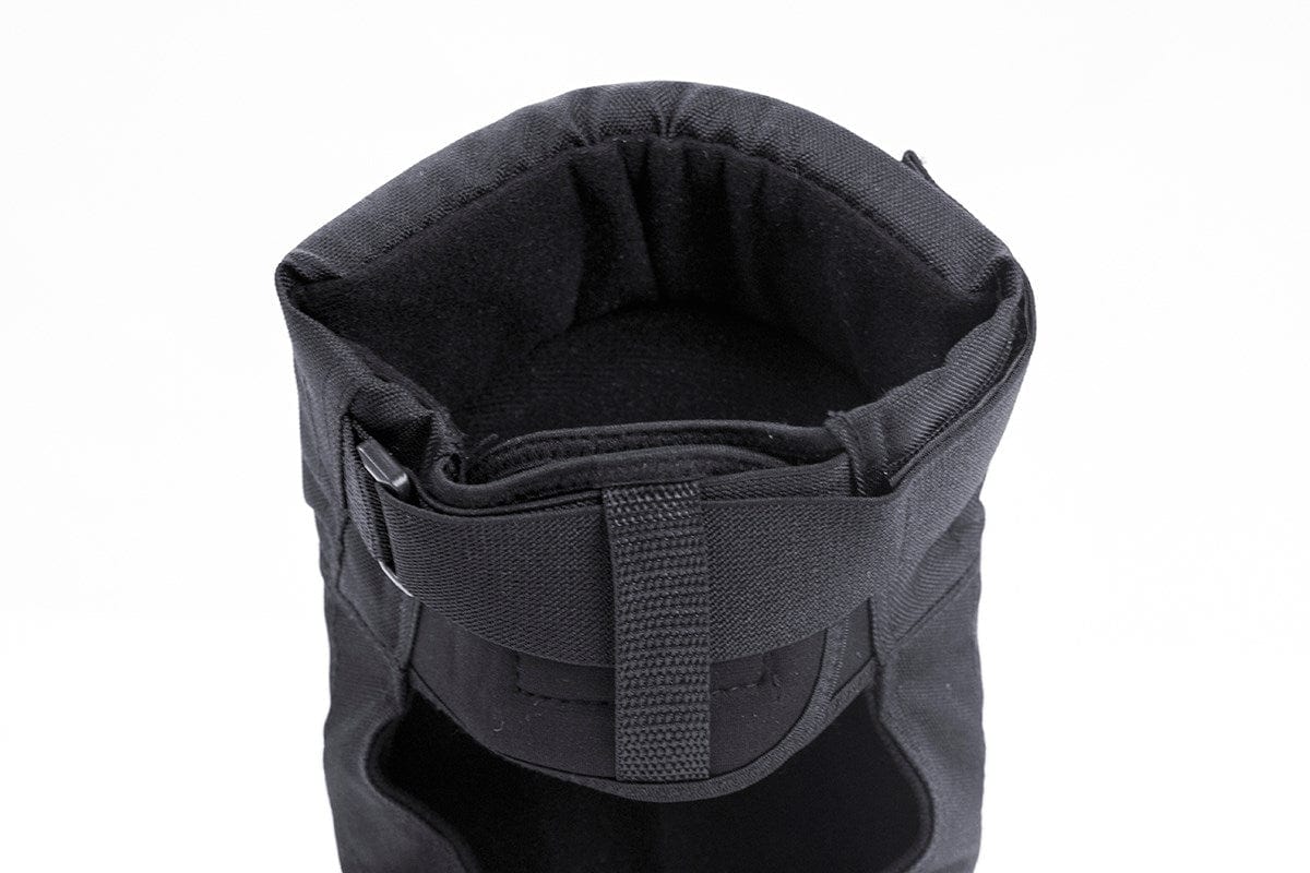 Top view of a black insulated winter boot with a drawstring closure, highlighting its cushioned interior and reinforced fabric for warmth and durability, akin to the protection offered by REKD Pro Ramp Skate Protection Knee Pads - Black.