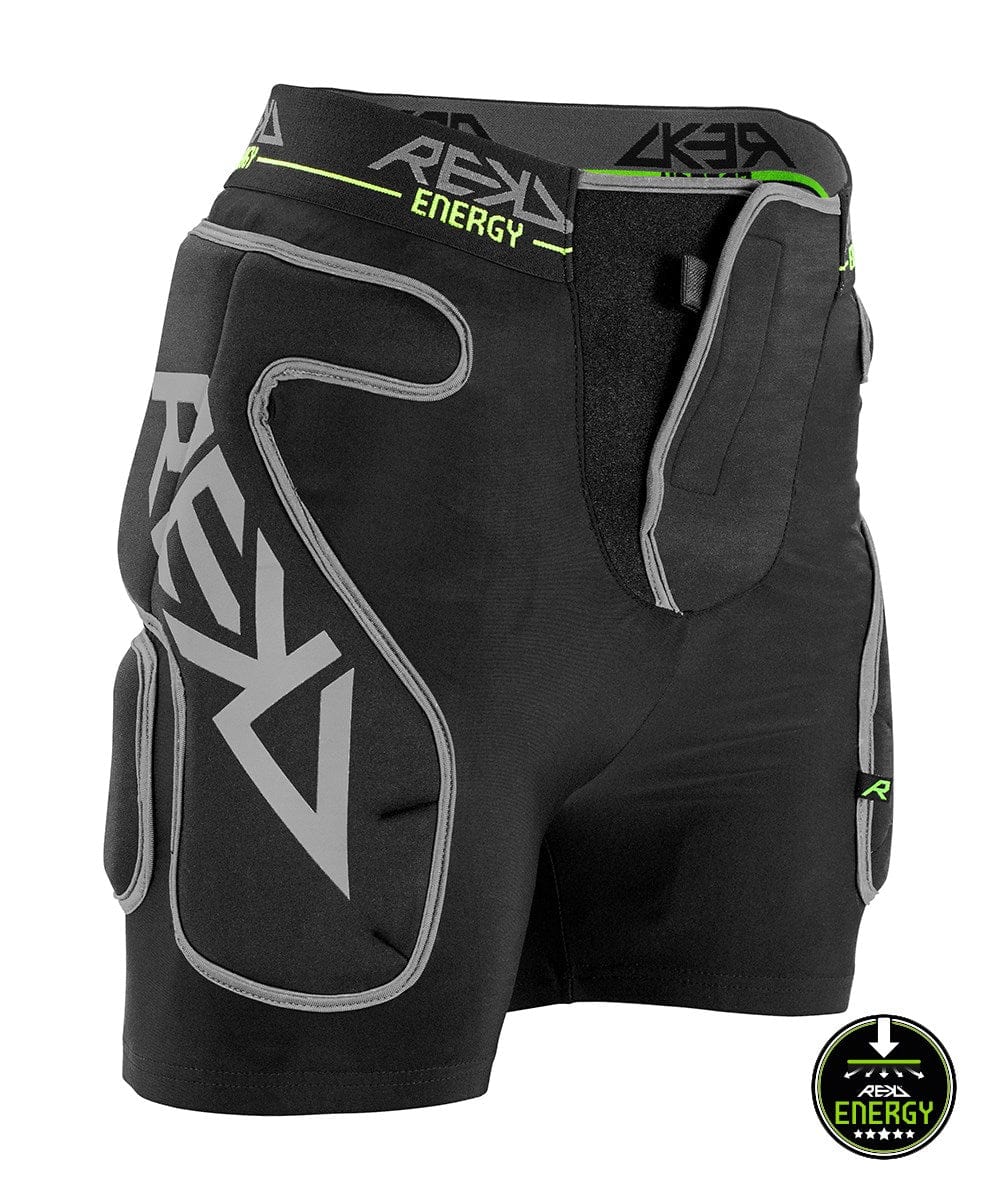 The REKD Energy Impact Skate Protection Shorts in black, featuring gray and green accents, are designed with multiple padded areas for coccyx bone protection. They showcase the "REKD" and "ENERGY" branding, along with a logo at the bottom right that reads "PROTECTION LEVEL 2.