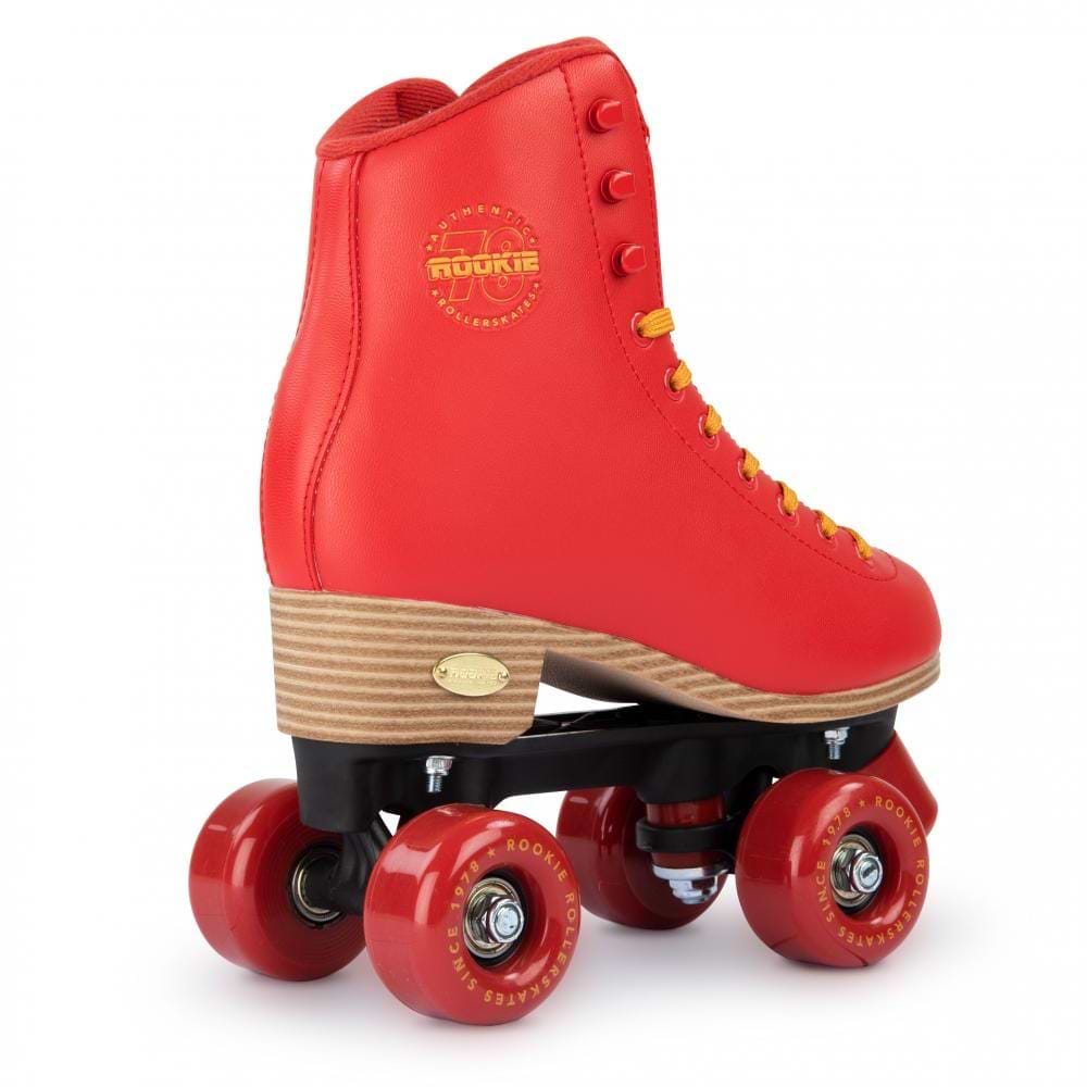 Introducing the Rookie Classic 78 Quad Roller Skates in Red: these vintage-inspired, vegan-friendly skates feature a striking wooden sole, a sleek black base, four vibrant red wheels, sunny yellow laces, and an elegantly embossed gold logo on the side.