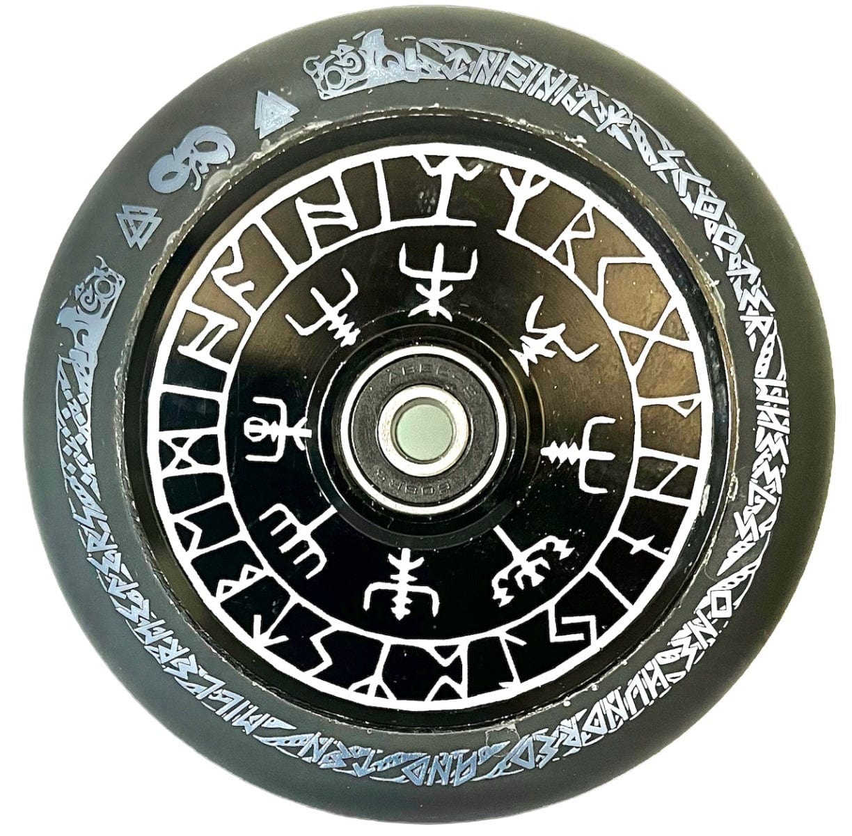 An Infinity Viking 110mm Hollowcore Stunt Scooter Wheel - Runes, round and black with detailed white rune-like designs circling its surface, is centered by a metallic hub. This wheel is recognized for its lightweight construction and high rebound PU material, making it perfect for smooth rides and agile maneuvers.