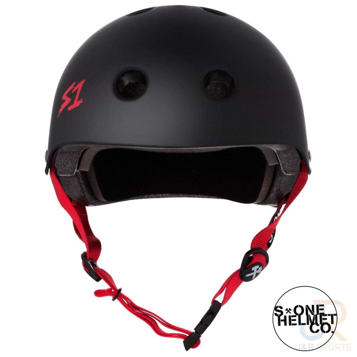 The S1 Lifer Skate / Scooter Helmet in matte black features EPS Fusion Foam technology, red straps, and a small red "S1" logo on the front. It is equipped with several ventilation holes and a padded interior. Additionally, a circular "S-One Helmet Co" logo appears in the bottom right corner of the image.