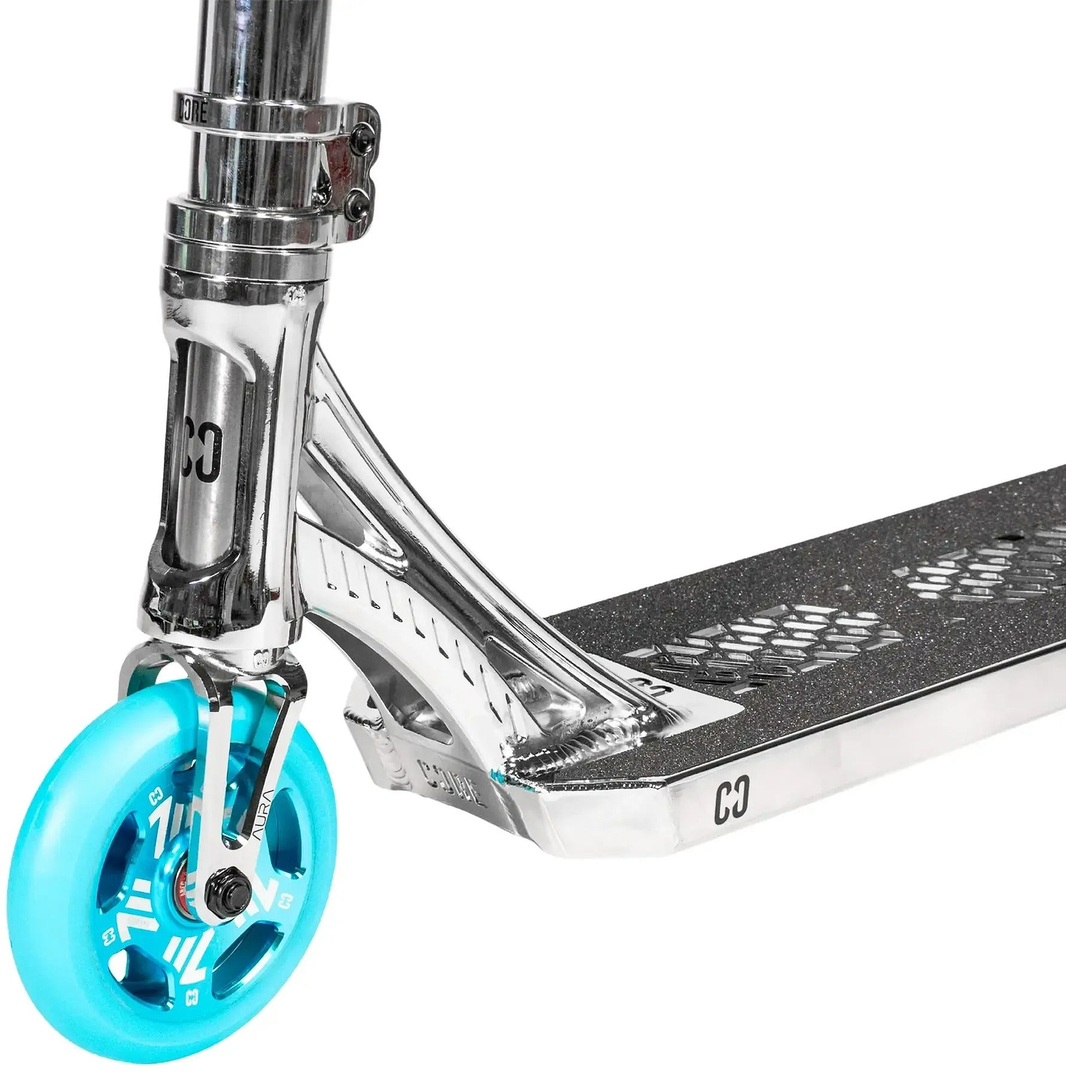 Close-up of the CORE SL3 Mini Complete Stunt Scooter by CORE in Chrome / Teal, highlighting its blue front wheel, metal fork, and black grip tape with cut-out hexagon patterns on the deck.