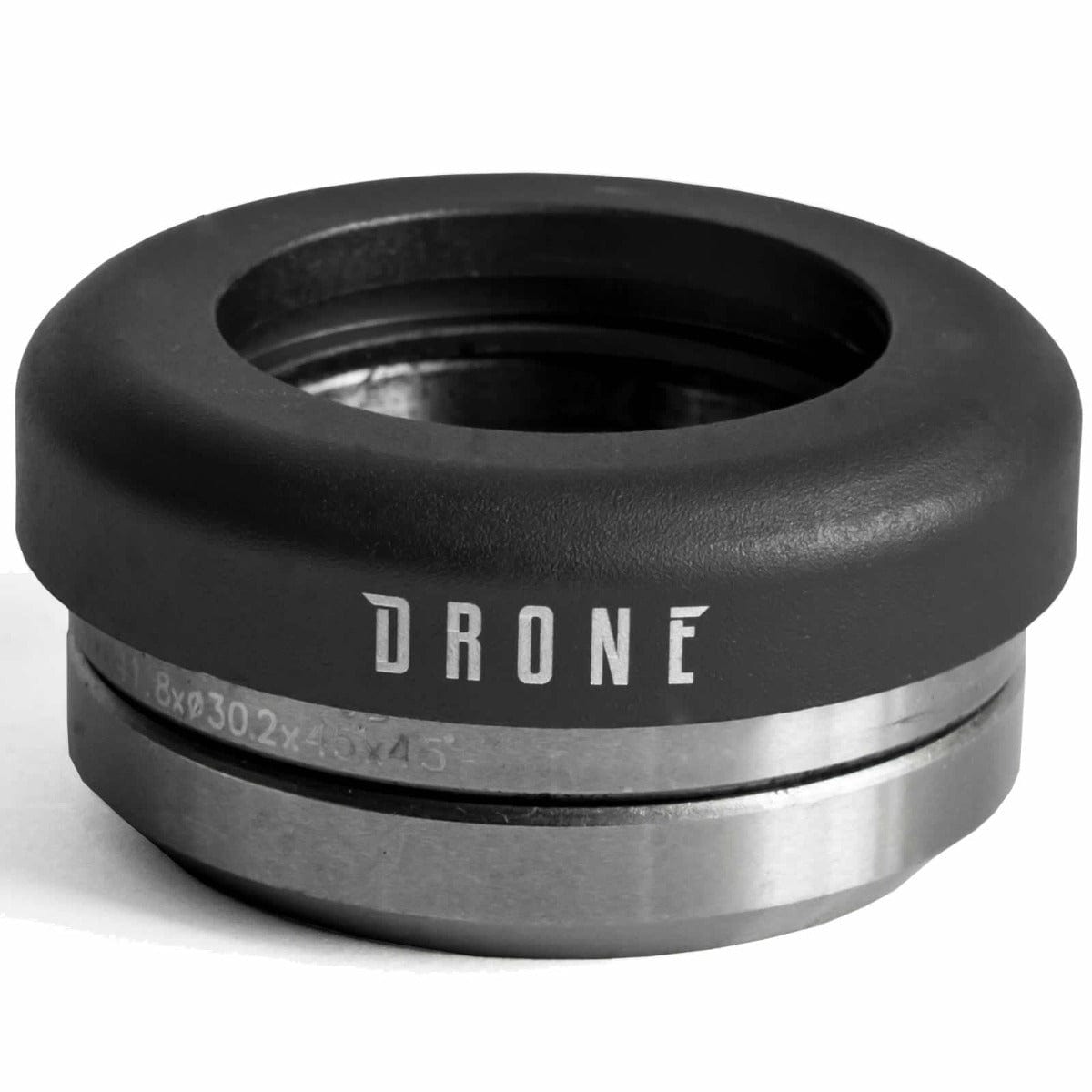 A close-up image of a metallic headset component, part of the Drone Synergy 2 Integrated Stunt Scooter Headset by Drone, displays "DRONE" engraved on it. It features smooth bearings and a 6061 aluminium top cap with a sleek, rounded black top and polished silver bottom, ideal for an integrated stunt scooter setup.