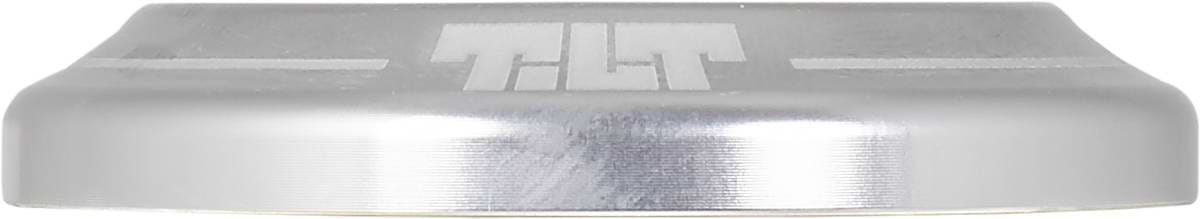 A close-up of a silver metallic, rounded object with "TILT" engraved on its side shows the smooth, brushed finish and precise design of the Tilt Integrated Stunt Scooter Headset - Silver by Tilt.
