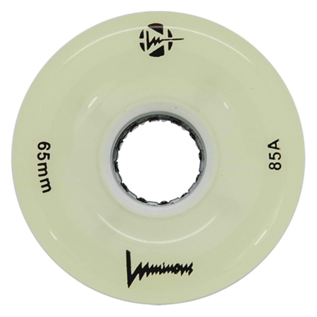 A cream-colored Luminous LED 85A Quad Roller Skate Wheel (White Glow, 65mm) has "65mm" and "85A durometer" printed on it, a central axle hole, the Luminous brand name, and black logos.