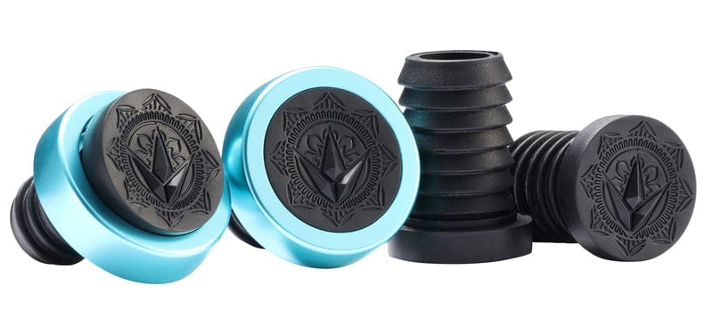 A set of four ornately designed blue and black wine stoppers, featuring circular tops with intricate patterns. Made from thermoplastic rubber, they provide a secure seal comparable to the Blunt Envy Will Scott Black / Teal Stunt Scooter Grips - 170mm by Blunt Envy, ensuring bottles are perfectly sealed.