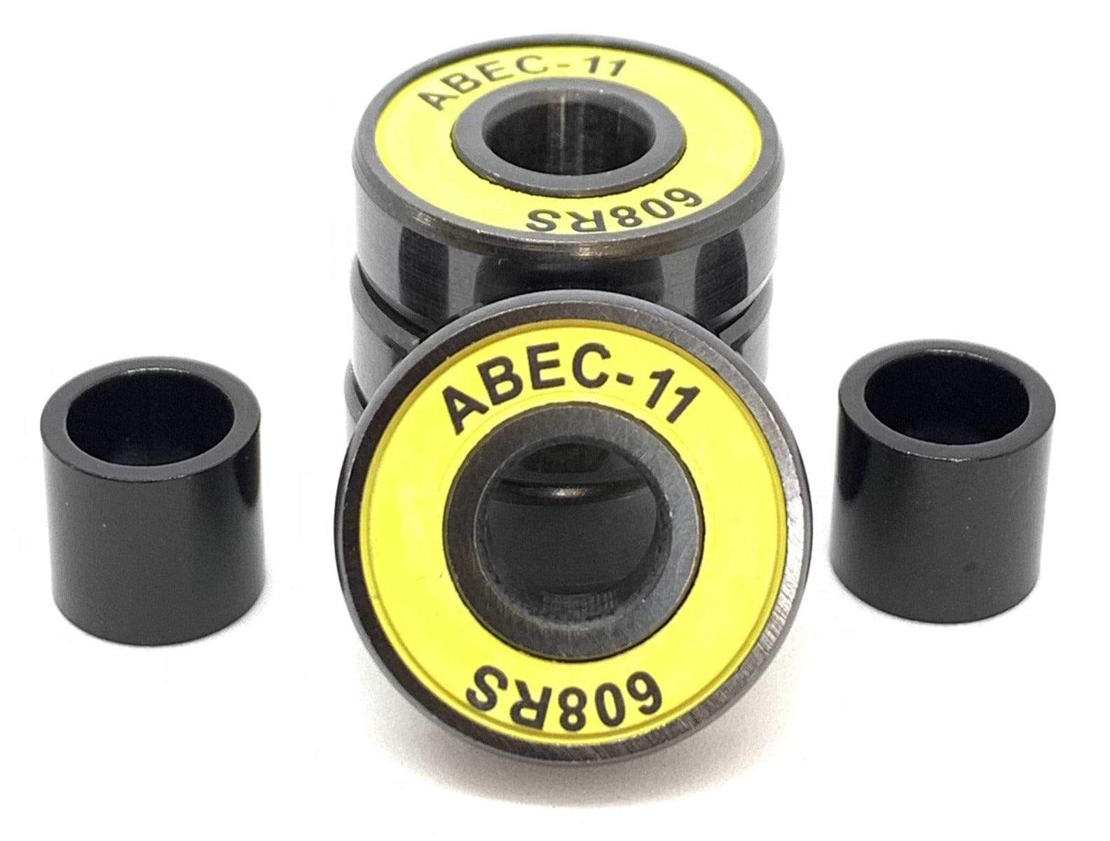 Close-up of a pack of four Logic ABEC 11 Yellow Scooter Bearings, featuring a striking black and yellow design, labeled "608RS" for optimal speed performance. These premium bearings are accompanied by two sleek black cylindrical spacers, all set against a clean white background.