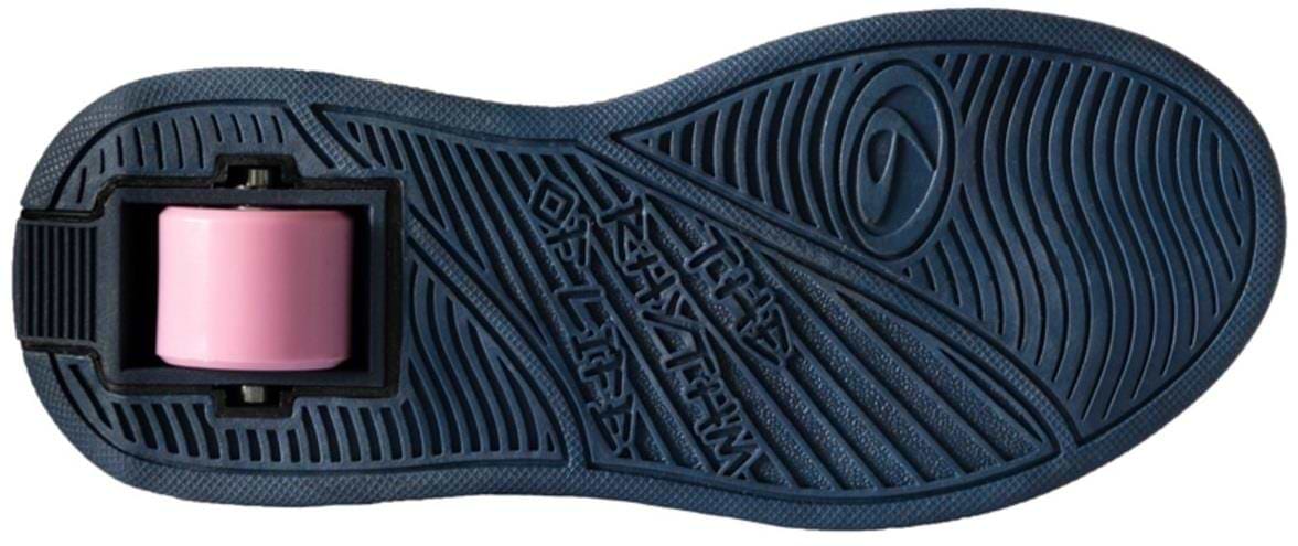 The image shows the bottom view of Breezy Rollers Blast Shoes - Purple by Breezy Rollers, featuring a dark blue sole with a single pink wheel in the heel. The patented wheel system and textured patterns offer both grip and smooth rolling.