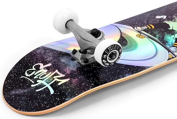 Introducing the Enuff Skully Hologram Black Complete Skateboard: an entry-level board with a 7-ply maple deck featuring vibrant space-themed graphics of planets and stars, silver trucks, and white wheels proudly displaying the Enuff brand.