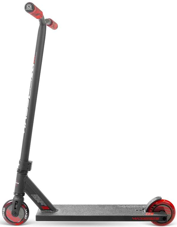 A Madd Gear (MGP) MG 3 Zen Complete Stunt Scooter in black and red is shown from the side against a white background, highlighting its upright handlebar, textured deck, and small red wheels.