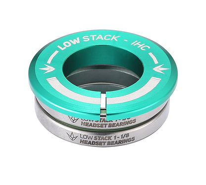 The Blunt Envy Low Stack IHC Integrated Stunt Scooter Headset in teal features sealed bearings and a distinctive arrow symbol. Its "LOW STACK - IHC" and "LOW STACK 1-1/8 HEADSET BEARINGS" labeling enhances its compatibility with the Blunt Envy Stunt Scooter, offering a sleek metallic finish through neatly stacked components.