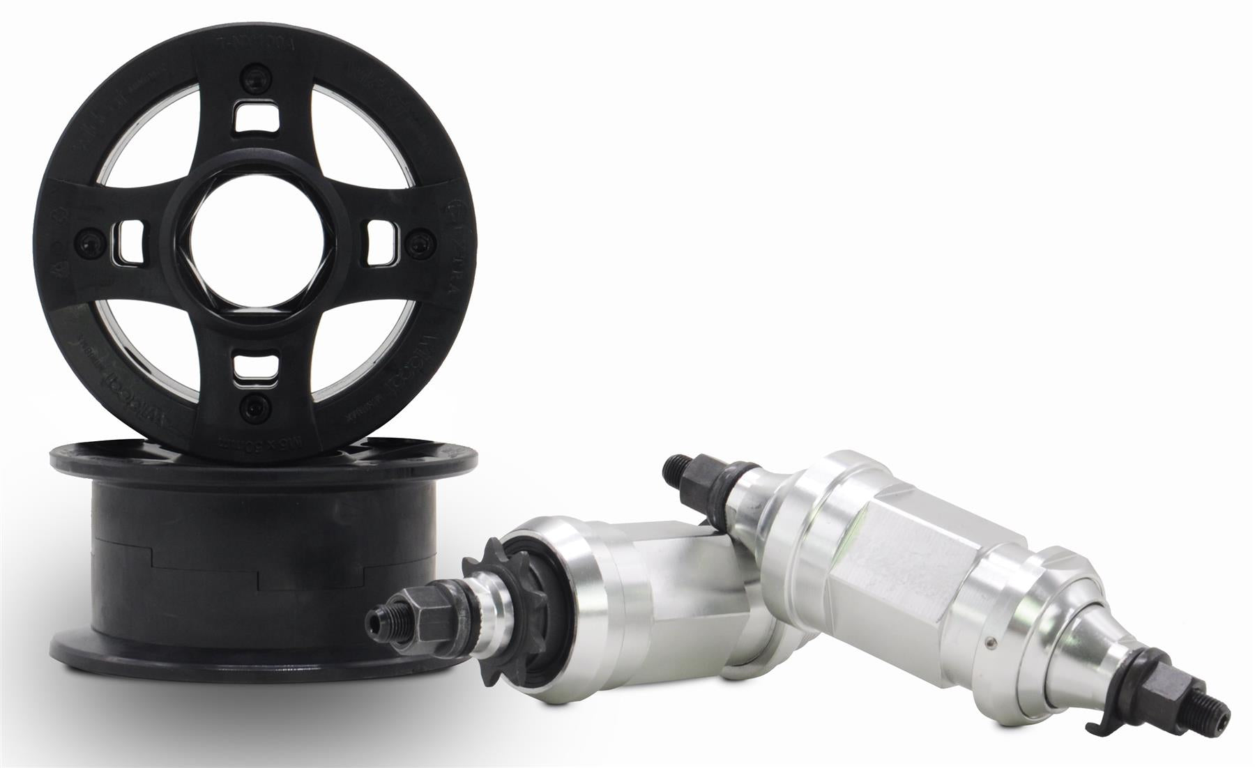 Two black CNC aluminum wheel rims stand and lie flat next to two metallic cylindrical, threaded components—parts from the Wildcat OG 3A Mini BMX Bike - Galaxy Gum by Wildcat—against a white background.
