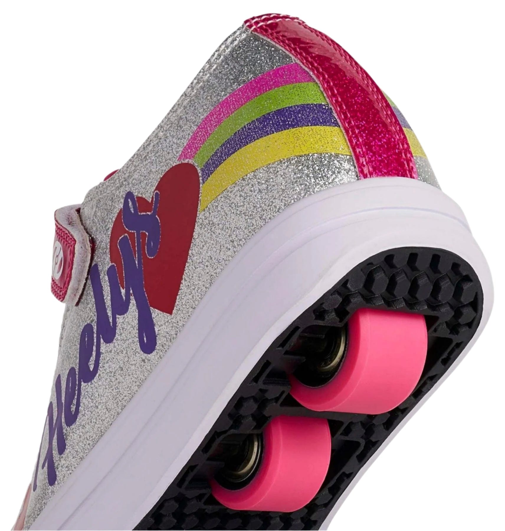 A close-up of the heel of Heelys Snazzy X2 Girls Shoes by Heelys, featuring a synthetic silver glitter upper, rainbow stripes, pink wheels with ABEC 3 bearings, and a red heart detail.