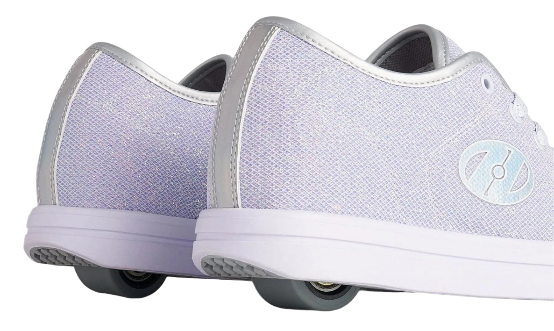 Close-up of Heelys Classic Em Girls Shoes by Heelys in Silver/White/Grey, featuring light purple mesh uppers, silver trim, and small retractable heel wheels with ABEC 3 bearings, shown partially extended.