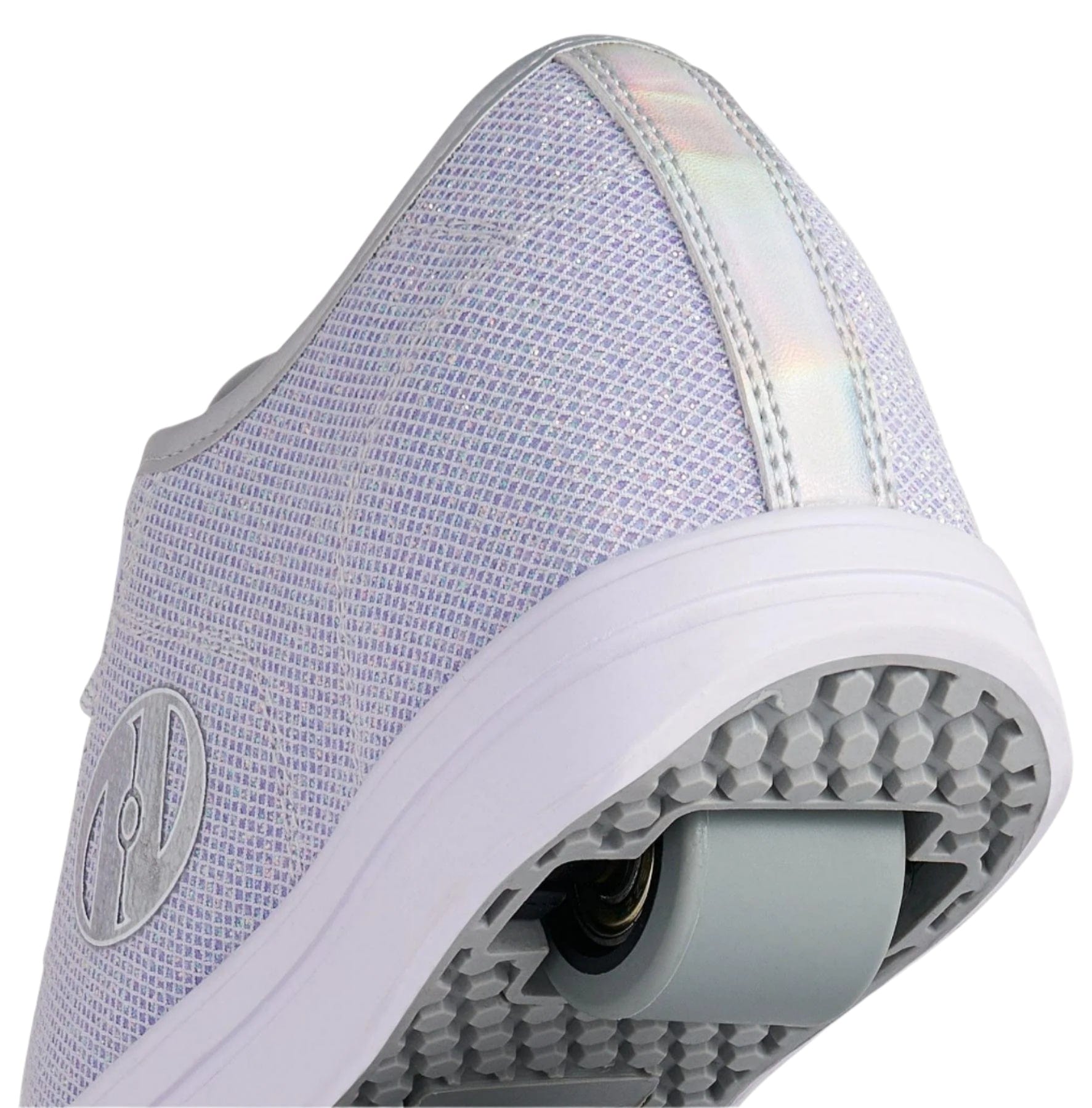 A close-up of the heel of Heelys Classic Em Girls Shoes in silver, white, and grey, featuring a built-in sole wheel with ABEC 3 bearings, a textured mesh upper, and a reflective strip on the back.