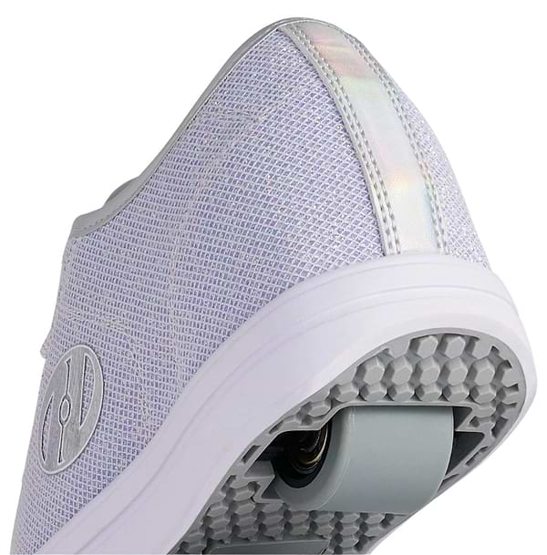 A close-up of the heel of Heelys Classic Em Girls Shoes in silver, white, and grey, featuring a built-in sole wheel with ABEC 3 bearings, a textured mesh upper, and a reflective strip on the back.
