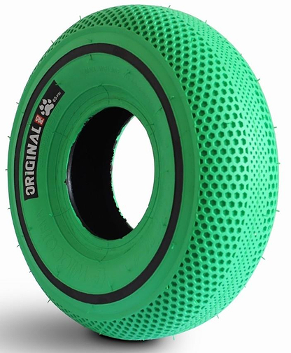 The Wildcat OG Pro Mini BMX Bike - Joker Green features a green, honeycomb-patterned airless tire with small protrusions, a black inner ring, a "ORIGINAL" side label, and a unique turbo wheel design. Brand: Wildcat.