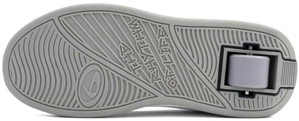 A close-up of the grey rubber sole of the Breezy Rollers Classic Shoes - White / Grey by Breezy Rollers, highlighting the patented retractable wheel system near the heel.